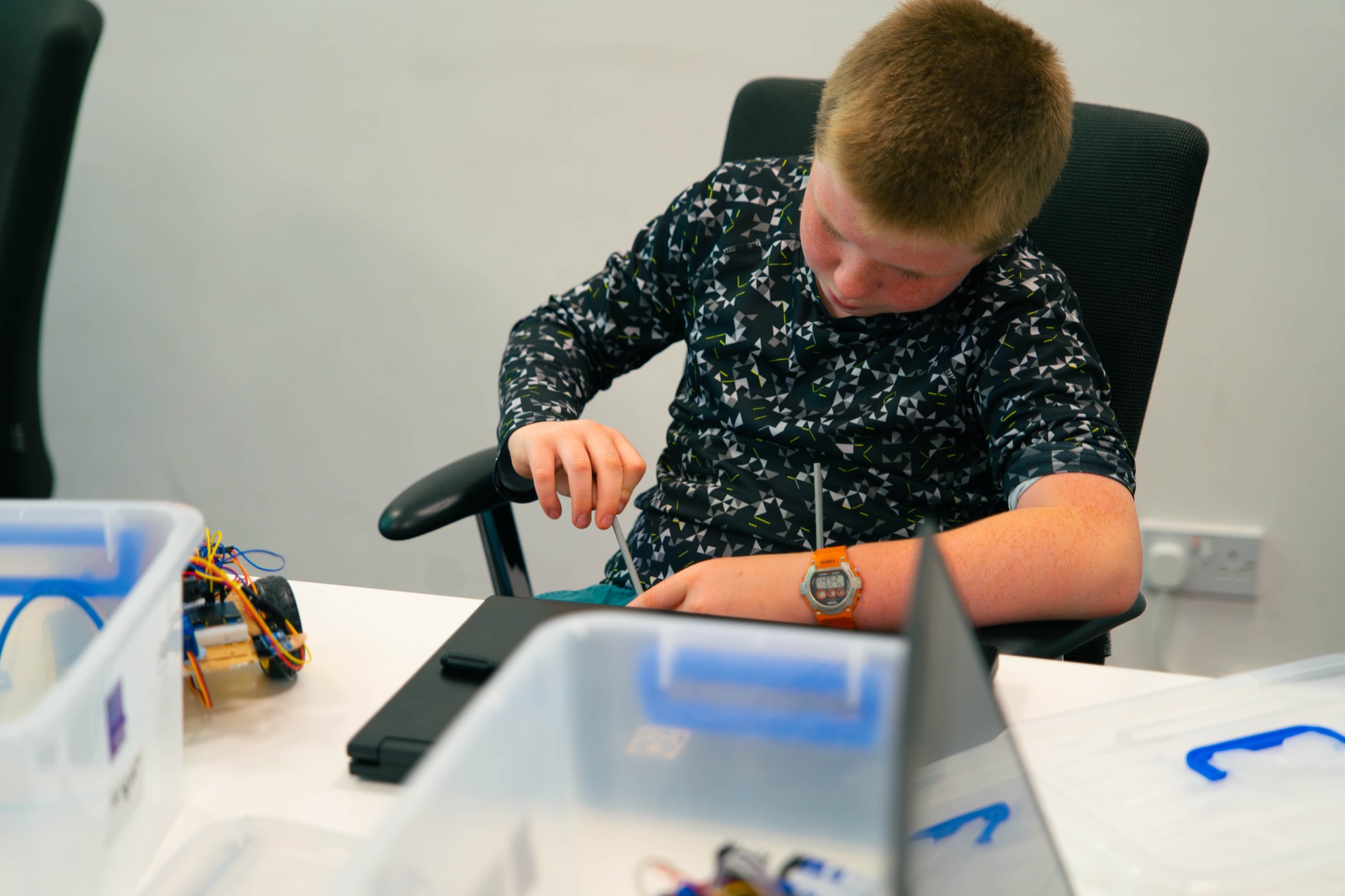 A Robocoder wiring an Arduino on a robot build, the practical work behind BCS Level 2.